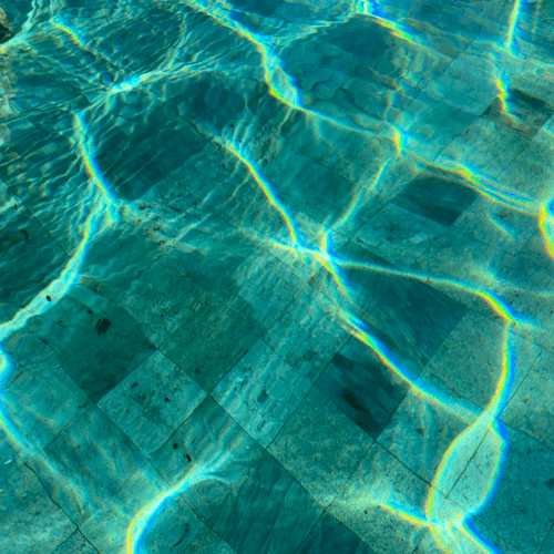 Sunlight rippling across the floor of a swimming pool
